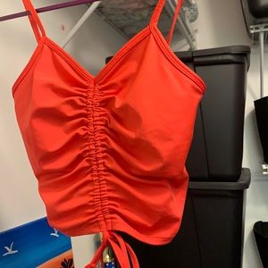 Cropped pinkish tank top tied in middle